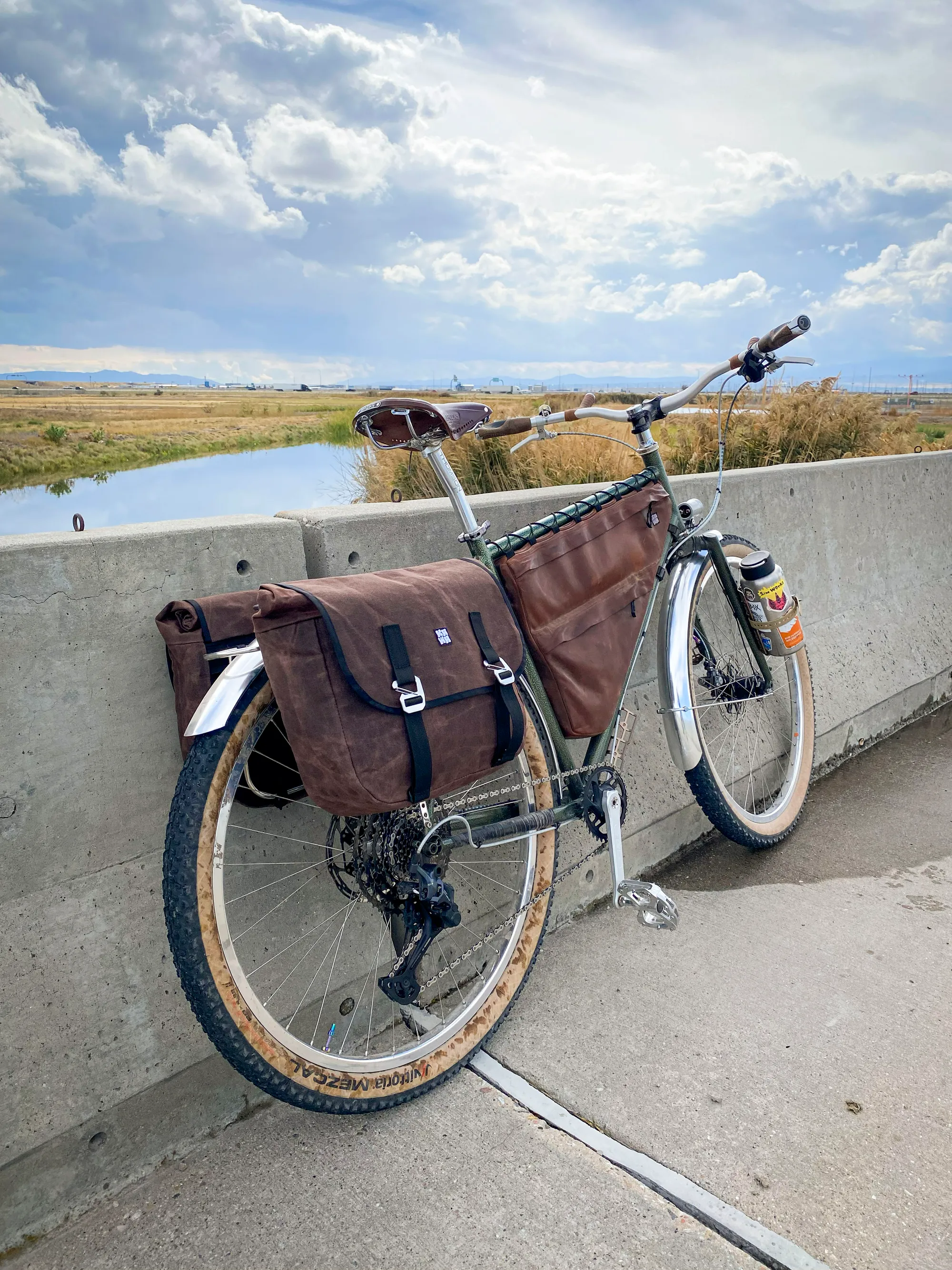 Waxed canvas touring panniers mounted on bike