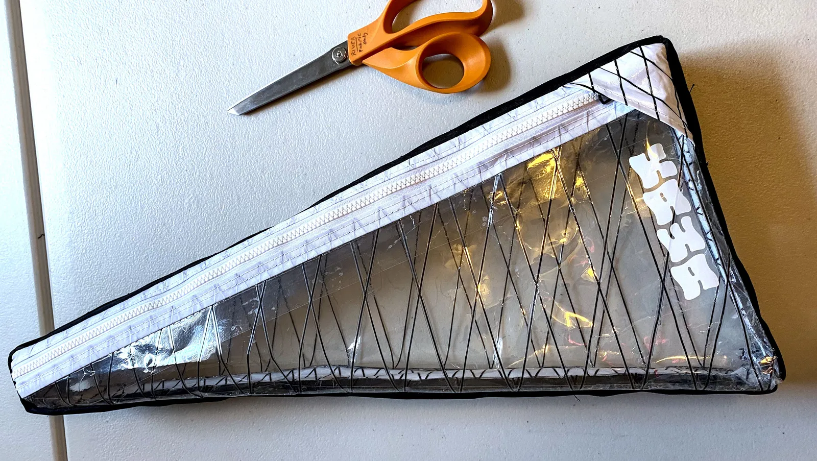 A clear Kawa framebag on a table with scissors