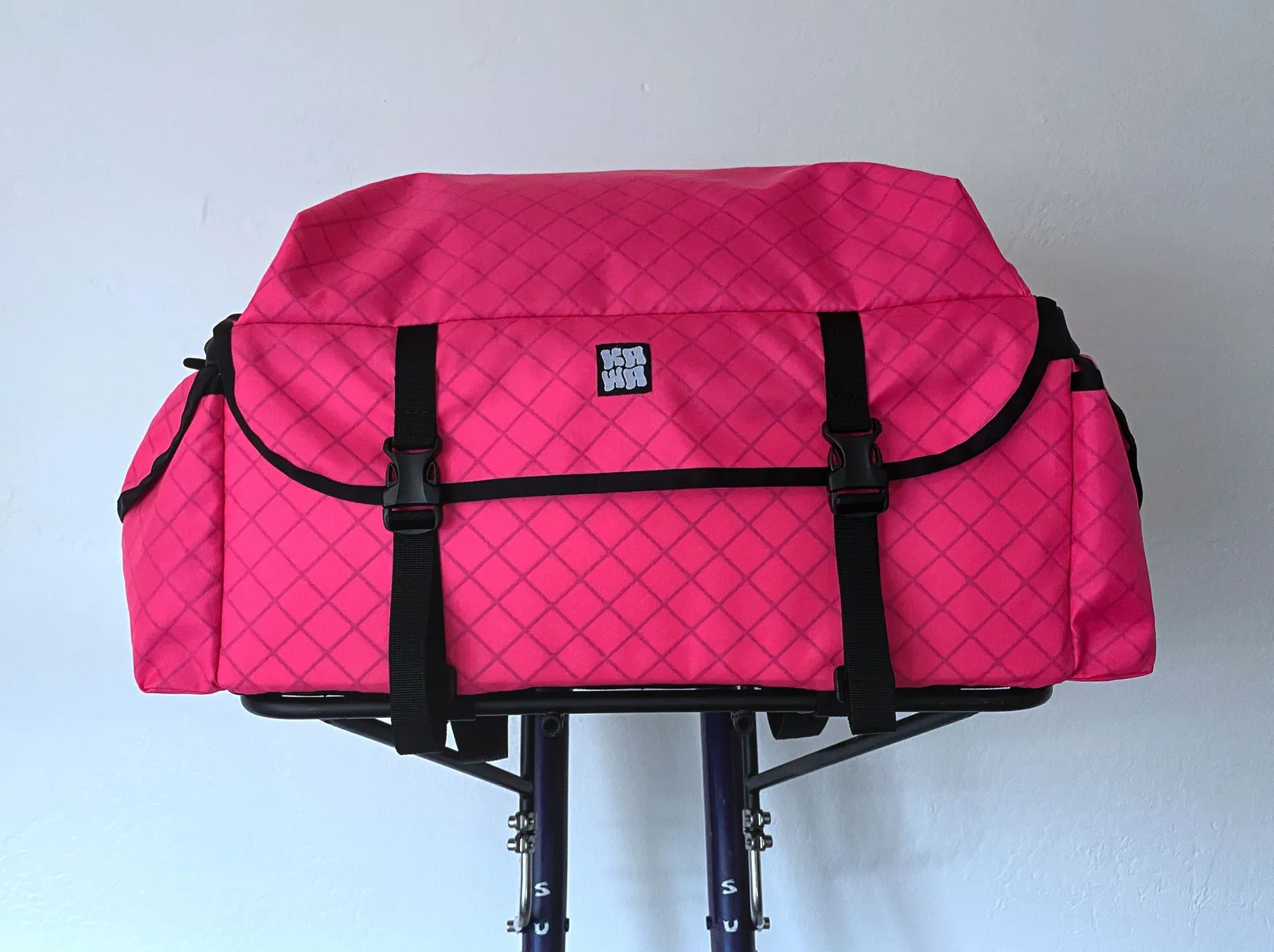 A pink front rack bag, large, on rack