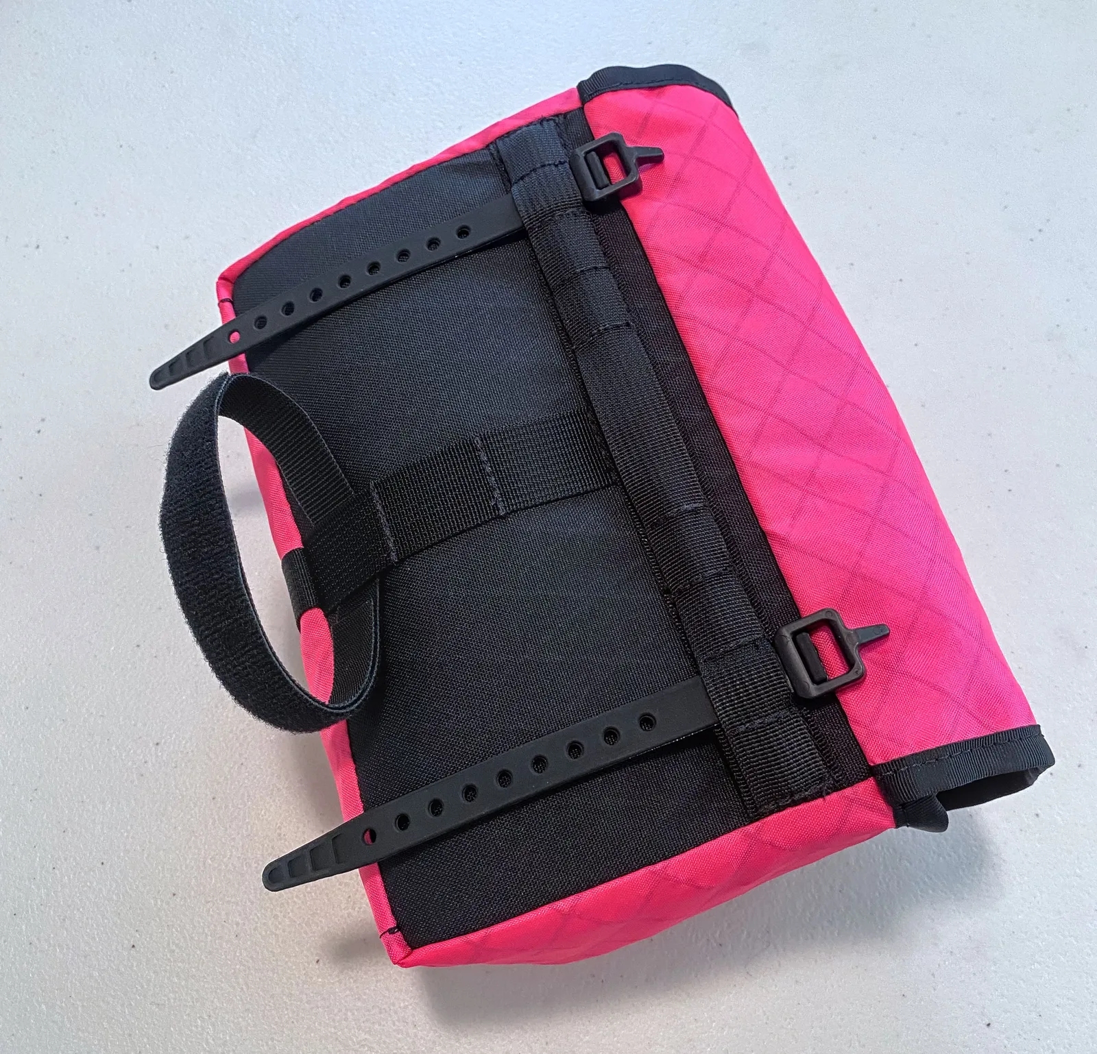 A small pink Kawa front bag, back view