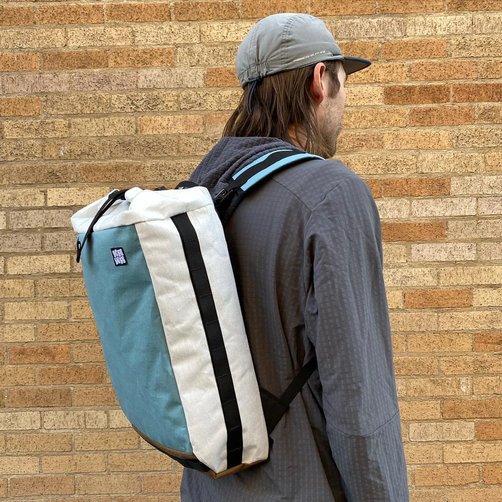 A white and blue Kawa backpack being worn