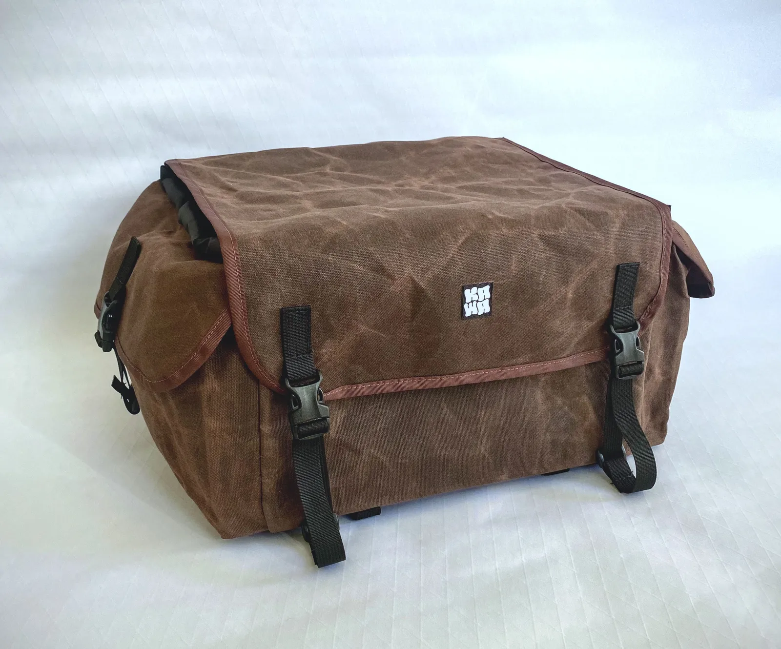 Brown canvas rack bag on white background