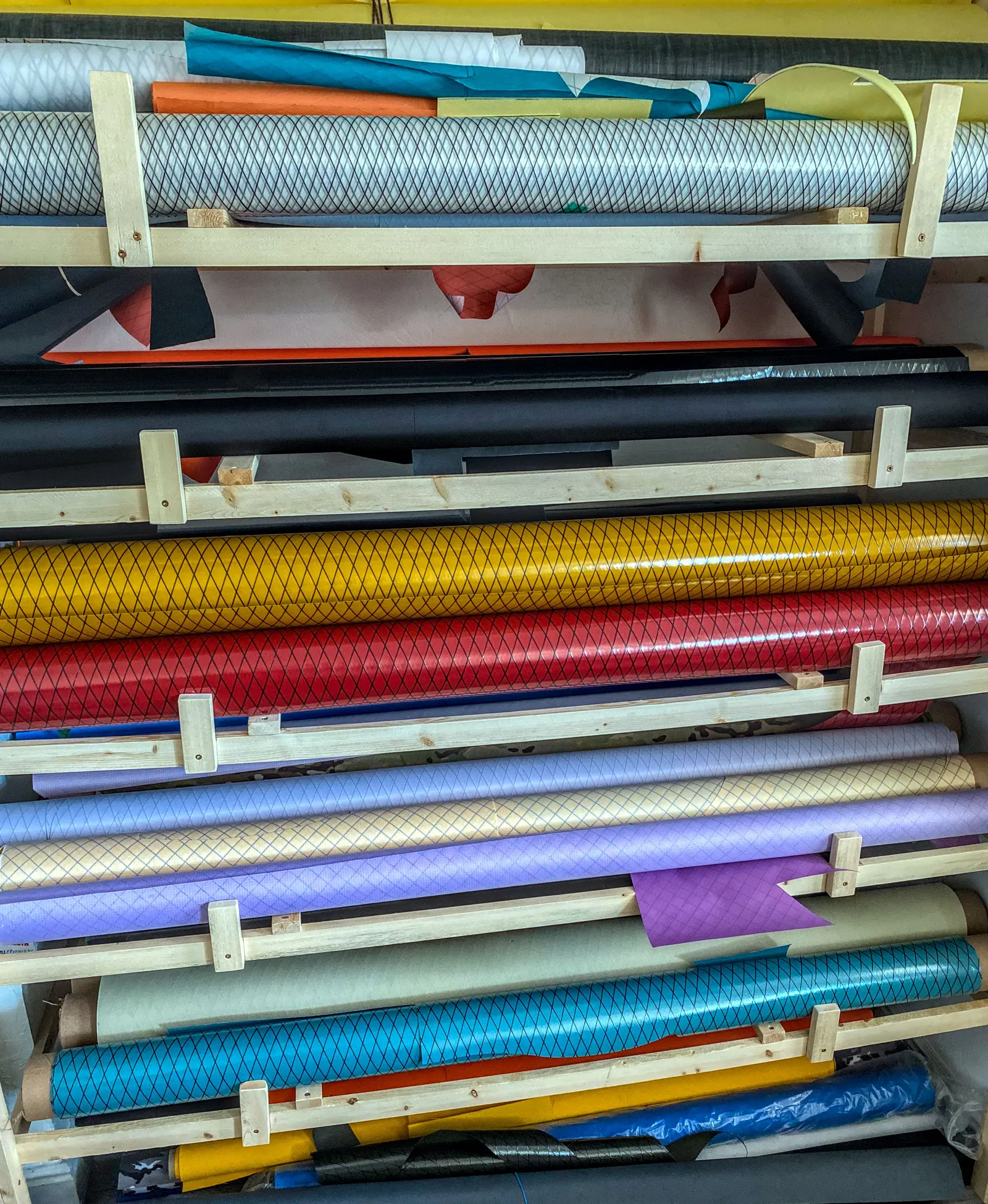 Rolls of fabric on shelves
