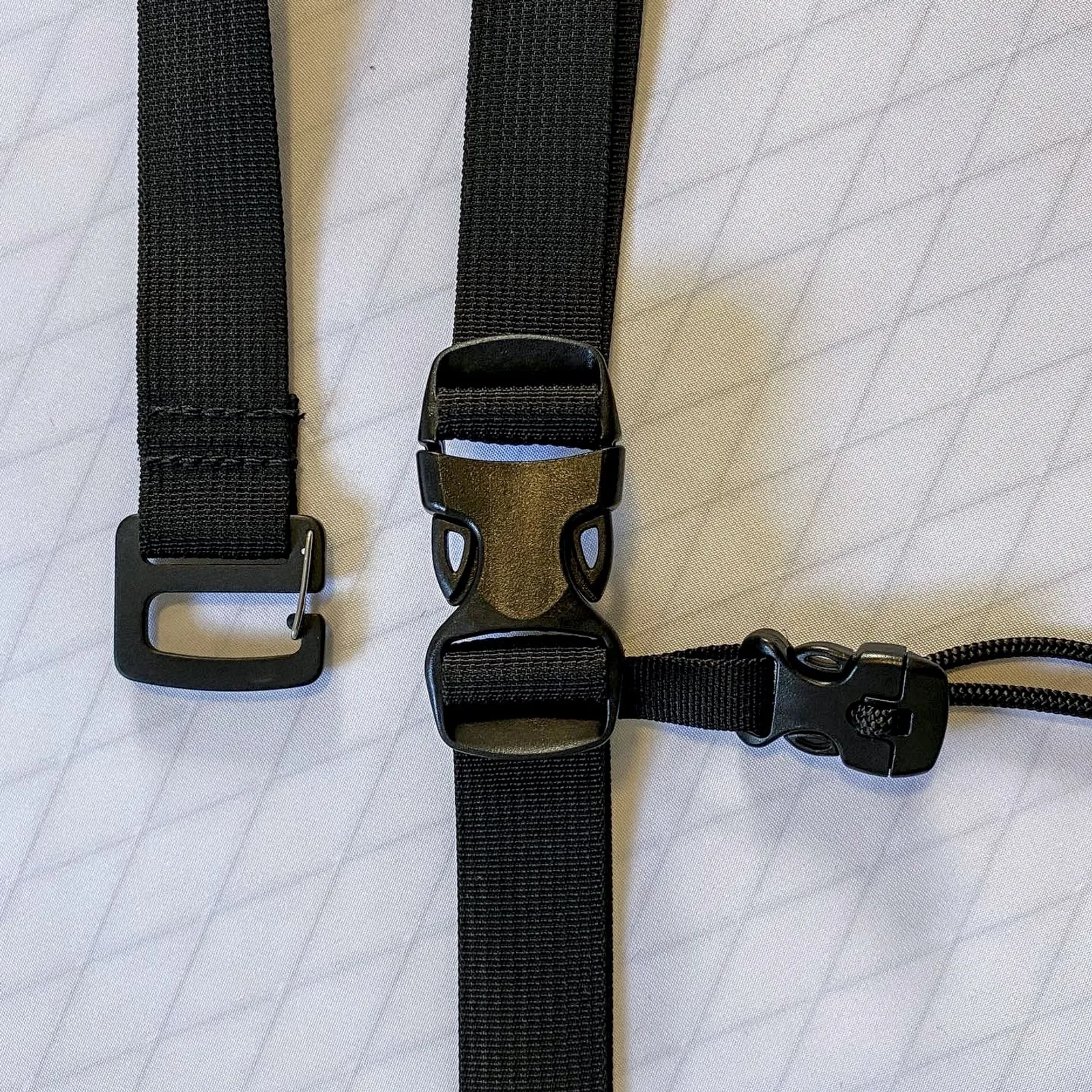 Straps and buckles on a white fabric background