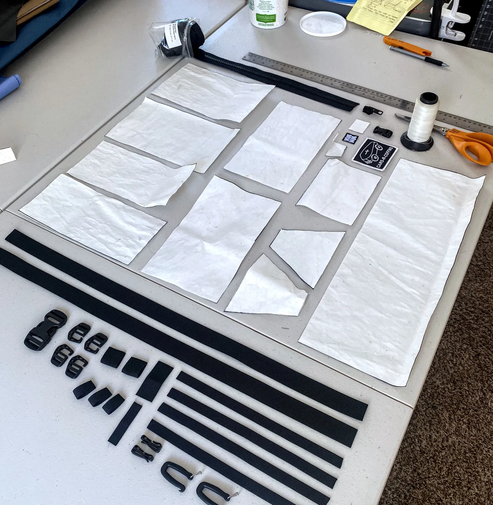 Table covered in white cut out pieces and parts for a prototype