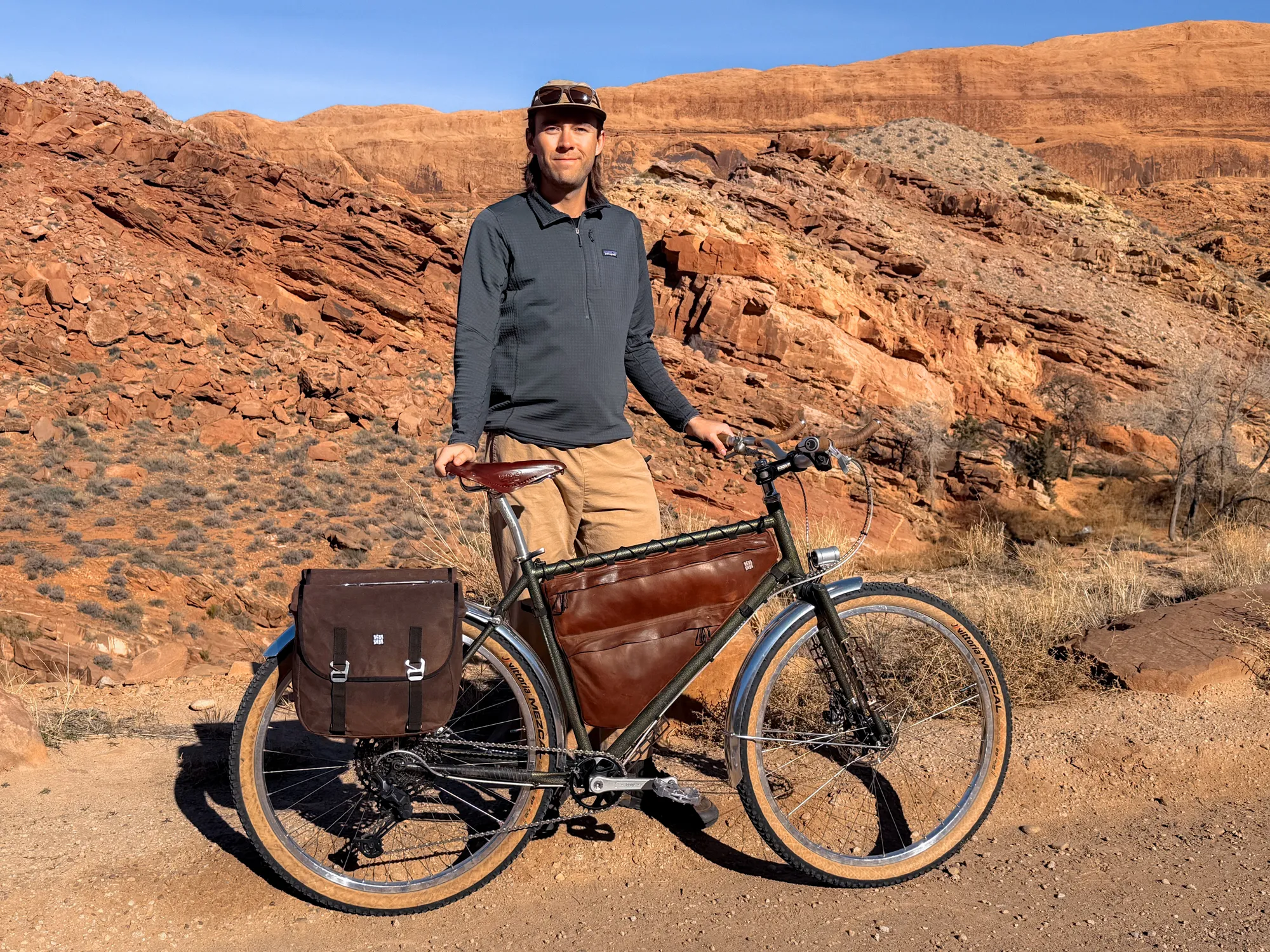 River standing with the fully loaded Piolet against red sandstone cliffs in Moab